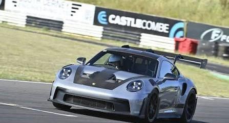 A silver Porsche 911 GT3 RS on track at Castle Combe